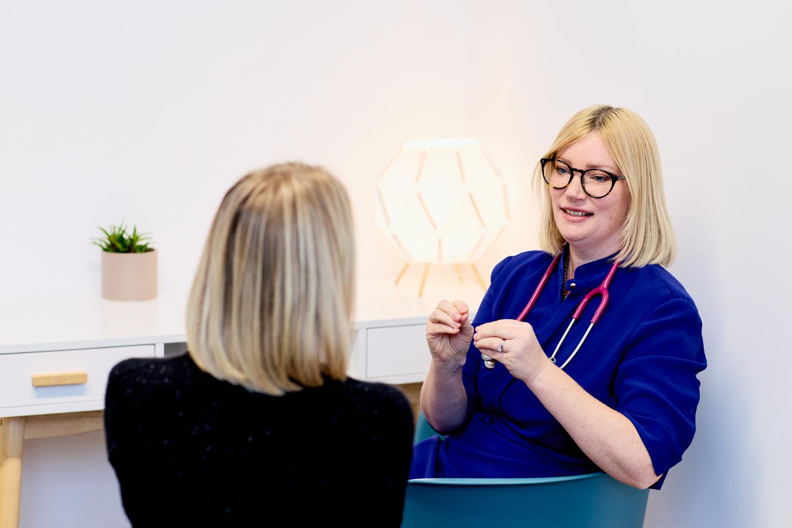 Dr Lorraine Kemp speaking with a patient about skincare options